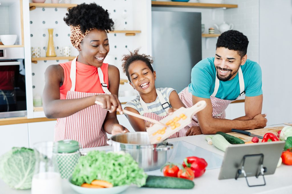 family child kitchen food daughter mother father cooking preparing breakfast happy together